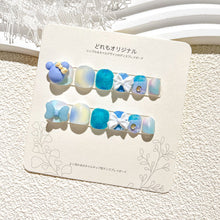 Load image into Gallery viewer, Cool-toned kids press-on nails featuring blue shades, glitter, and bow decorations