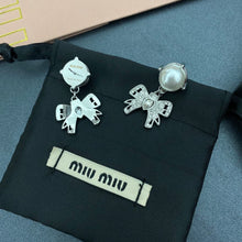 Load image into Gallery viewer, Platinum toned earrings with cute chic bows adorned with oversized resin pearls and white crystals