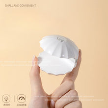 Load image into Gallery viewer, Compact Shell Mini UV Nail Lamp in hand
