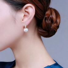 Load image into Gallery viewer, Lustrous Allure: 14mm Bright White Pearl Earring Adorned with Shimmering CZ Ear Hood
