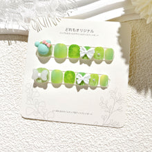 Load image into Gallery viewer, Green kids press-on nail collection with sparkling accents and white bow details
