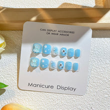 Load image into Gallery viewer, Sky blue kids press-on nails with snowflake designs and crystalline embellishments
