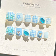 Load image into Gallery viewer, Aquatic blue kids press-on nails with starfish and seashell designs, glitter accents
